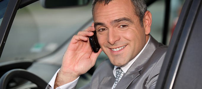 stockfresh_1943425_businessman-using-a-cellphone-in-his-car_sizesjpg