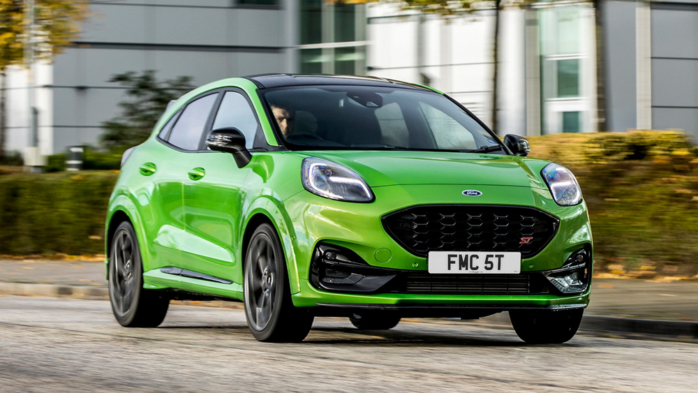 Bright green Ford Puma drives down a town road